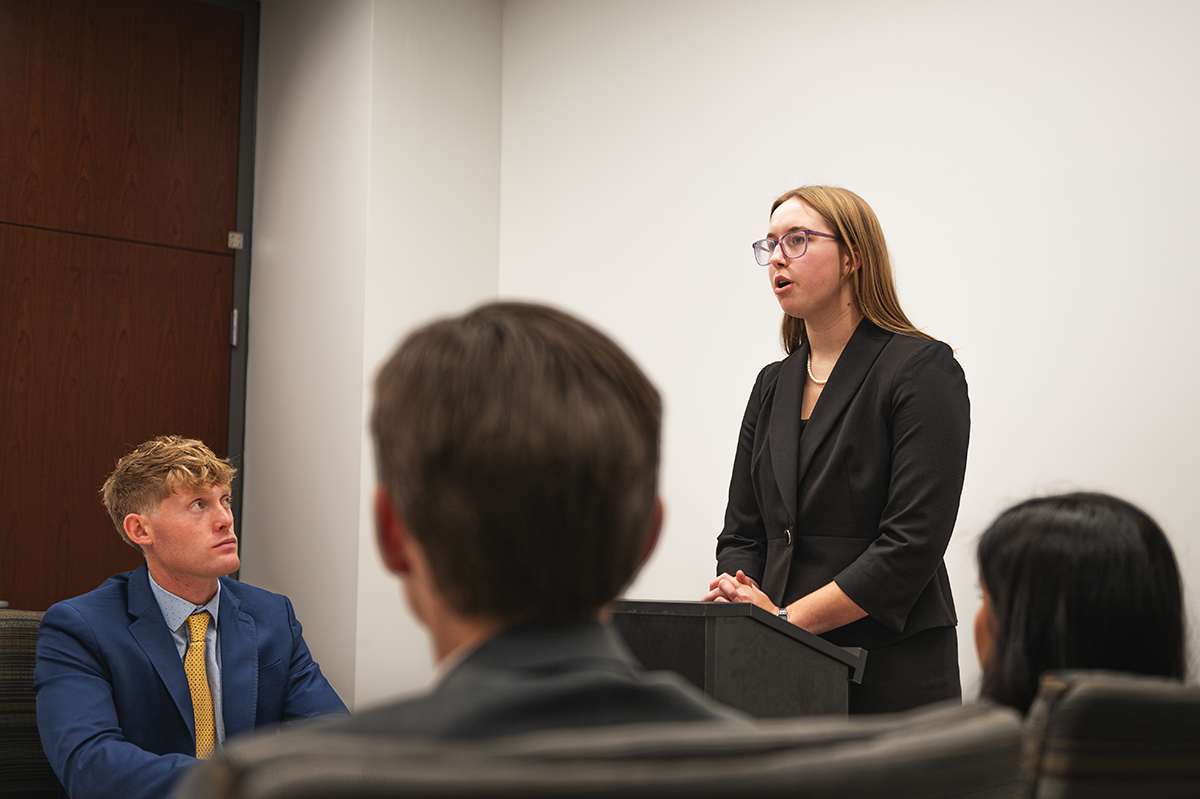 young woman speaking at podium